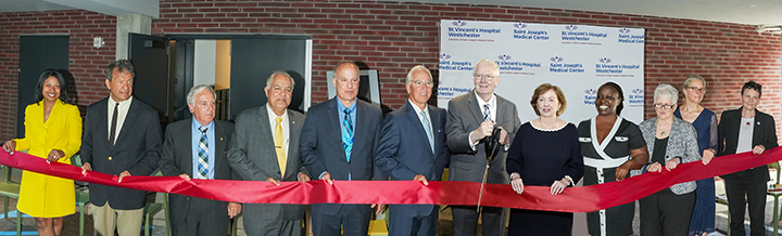 ribbon cutting with large group of officials