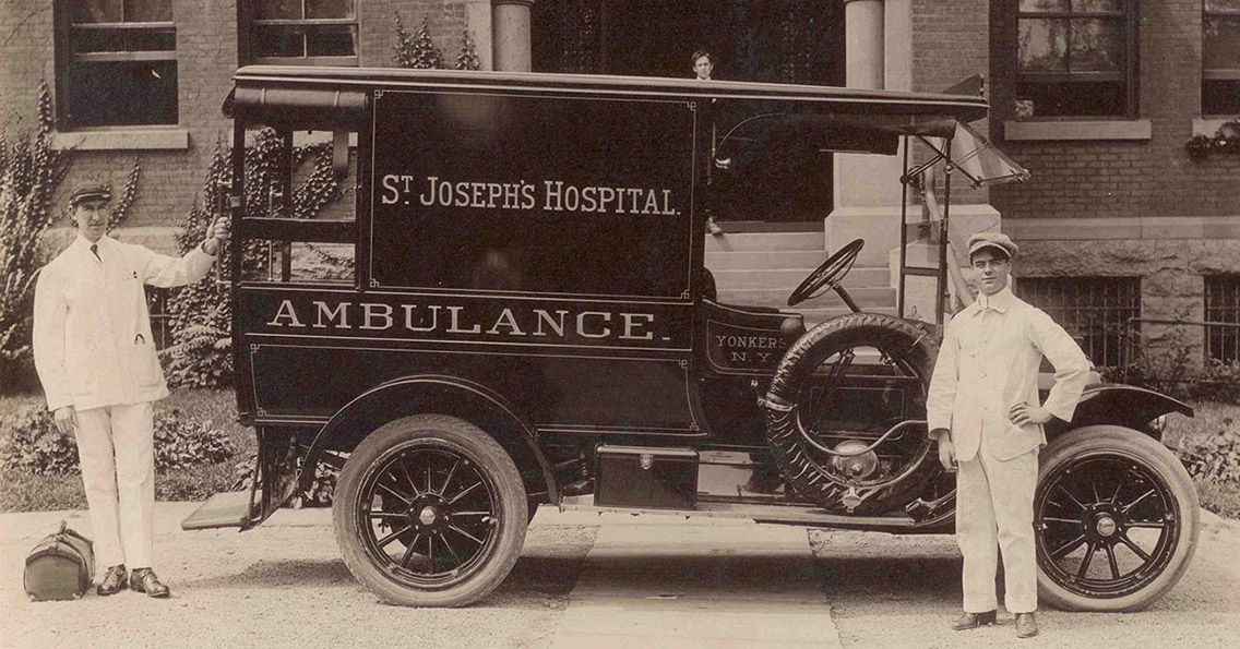 old fashioned St. Joseph's ambulance with two attendants